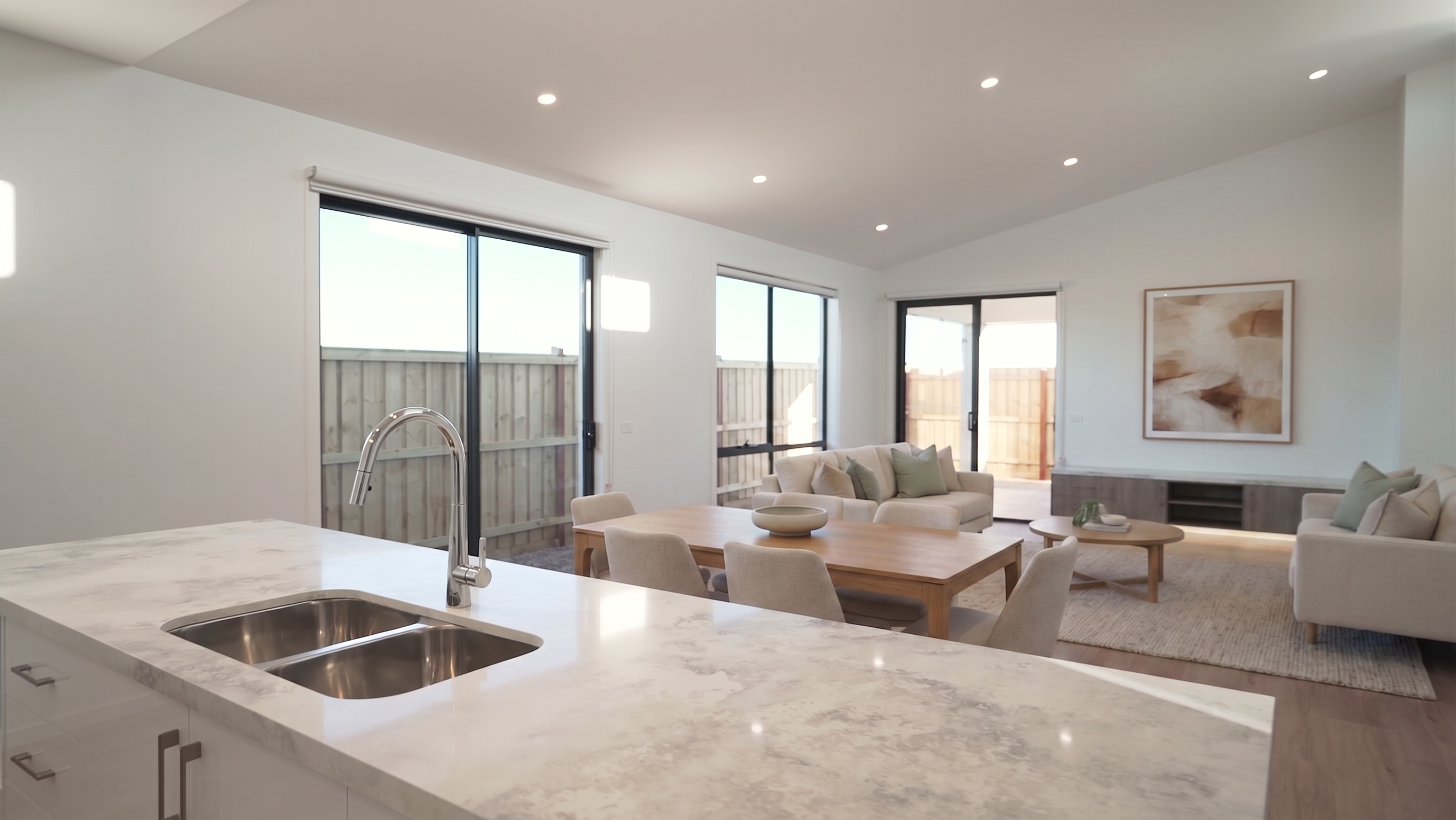 Open plan living and dining under the raked ceiling