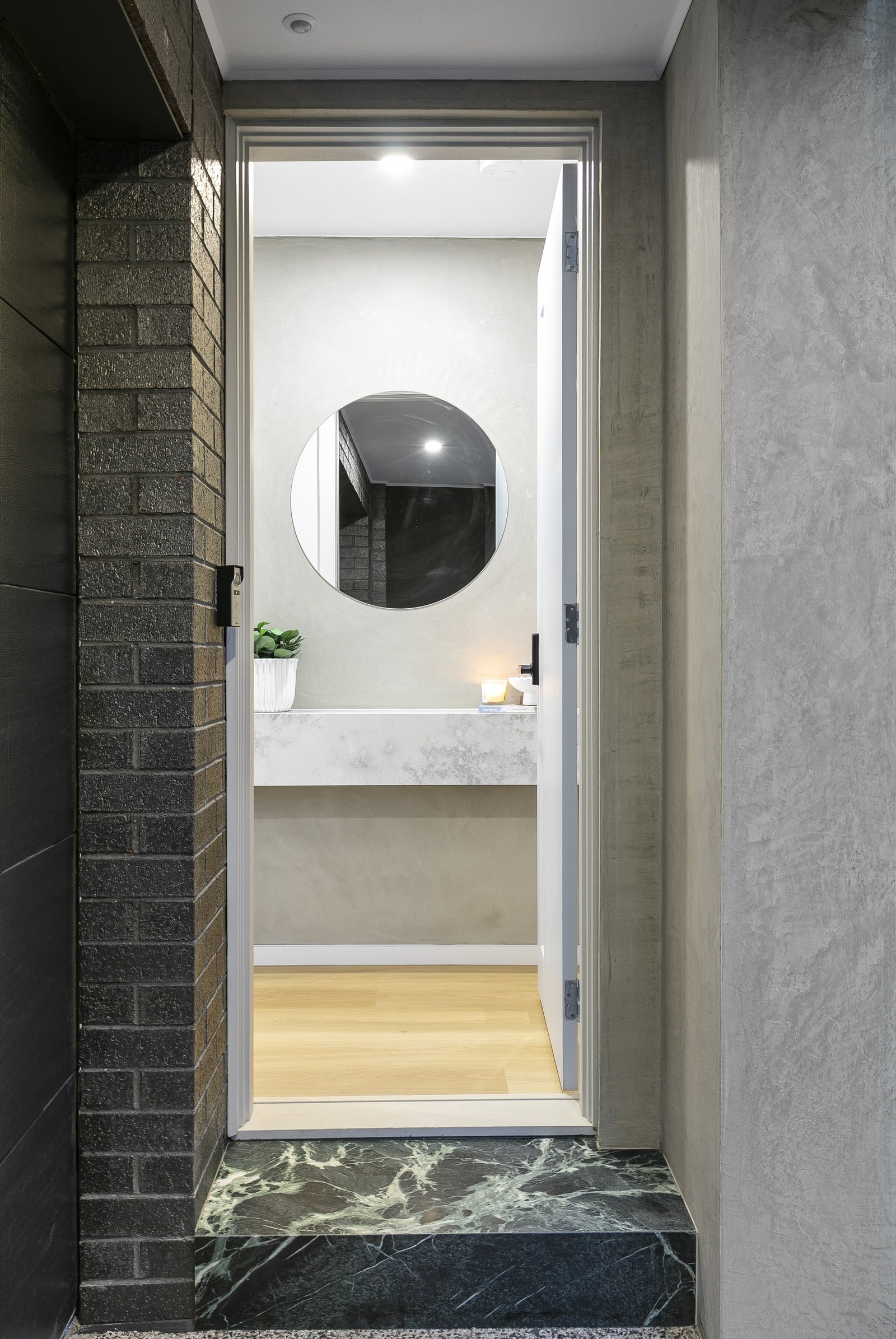 Entry with a natural deep green marble step