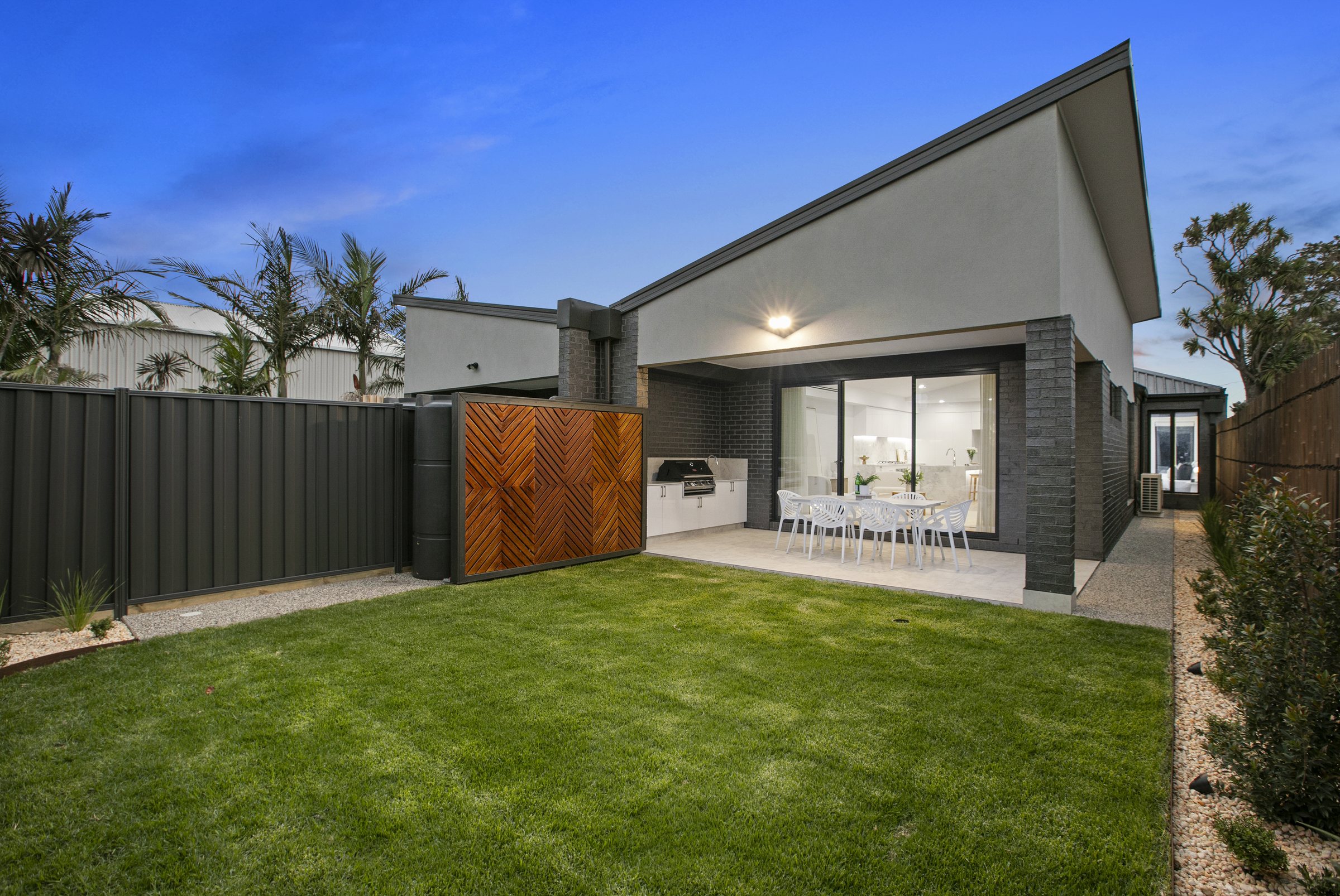The rear of the home from the backyard at dusk